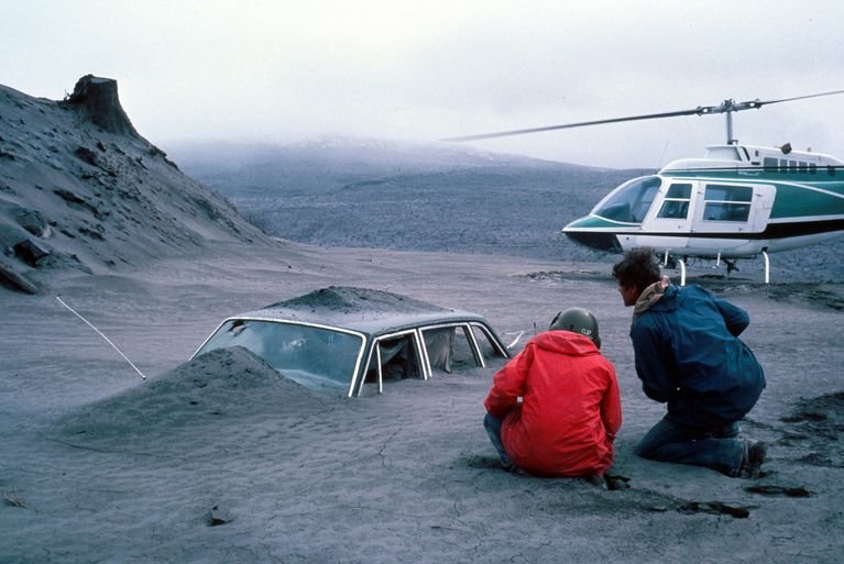 Scientists found the mountain's landscape transformed. Charlie Crisafulli recalled “seeing everything that had once been green was now shades of gray." USGS geologist Don Swanson (in red) and his colleague, Jim Moore, view a car filled with ash deposits.